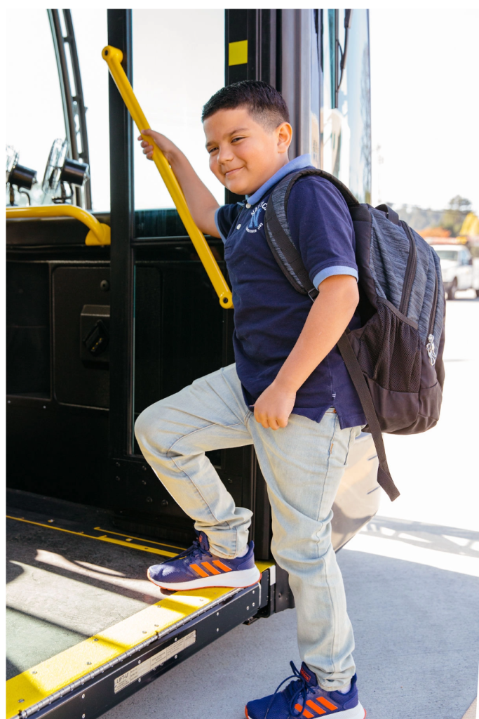 Boy getting on bus
